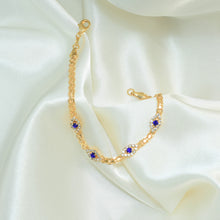 Gold plated bracelet with multiple sapphire blue evil eye charms