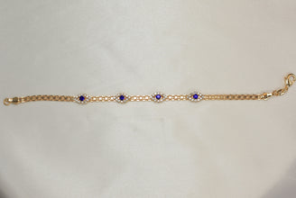 Gold plated bracelet with multiple sapphire blue evil eye charms