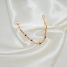 Gold plated bracelet with multiple sapphire blue evil eye charms